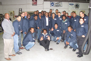 NCC trainees in the automotive program, which is backed by Ford, gathered around Baraka, center, along with staff from the Workforce Development Center.