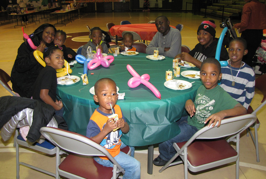 A family enjoys a hot meal at the annual Breakfast With Santa hosted by NCC Youth Services.
