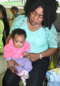 Olguine Lovincy holds her 2-month-old daughter Olguina.