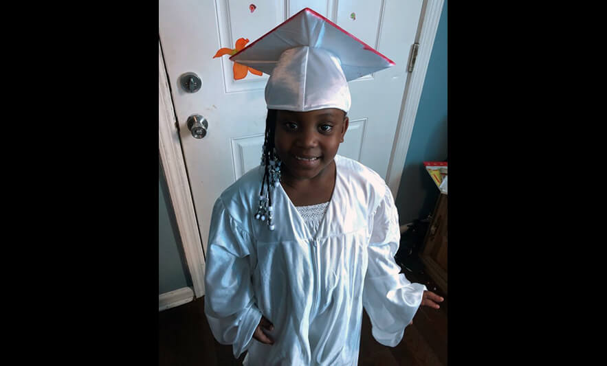HHELC Graduation 2020 Girl in White Cap and Gown Black Background