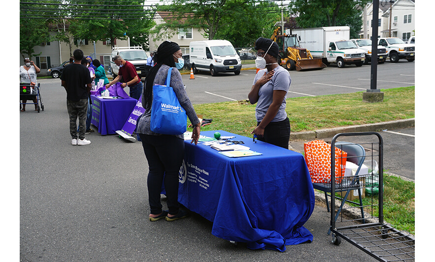 Extended Care Health Fair 7-29-2022 Woman at FSB table speaking with Dametria Wertz for web
