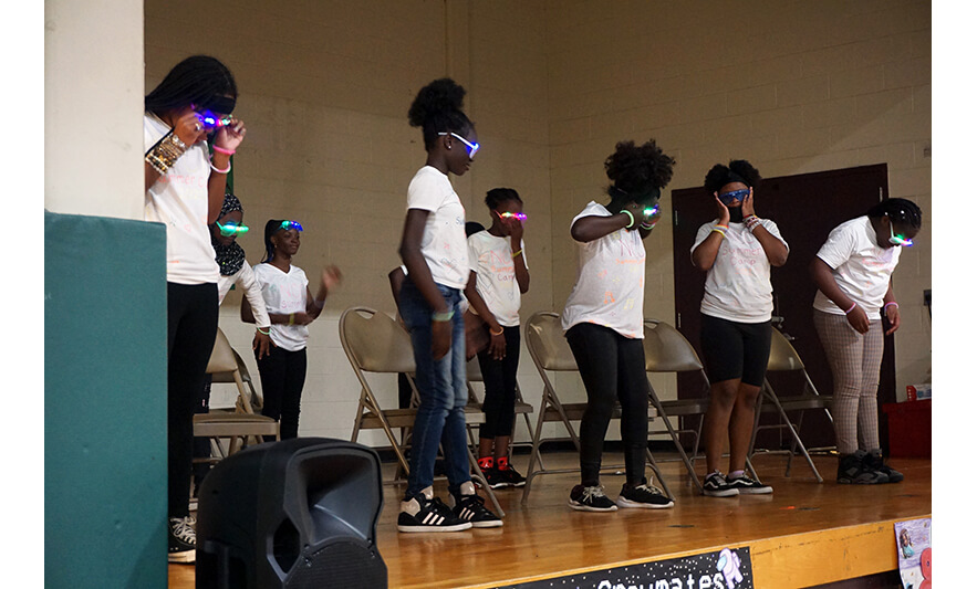 Summer Camp 2022 Finale Group with glowing glasses on stage for web