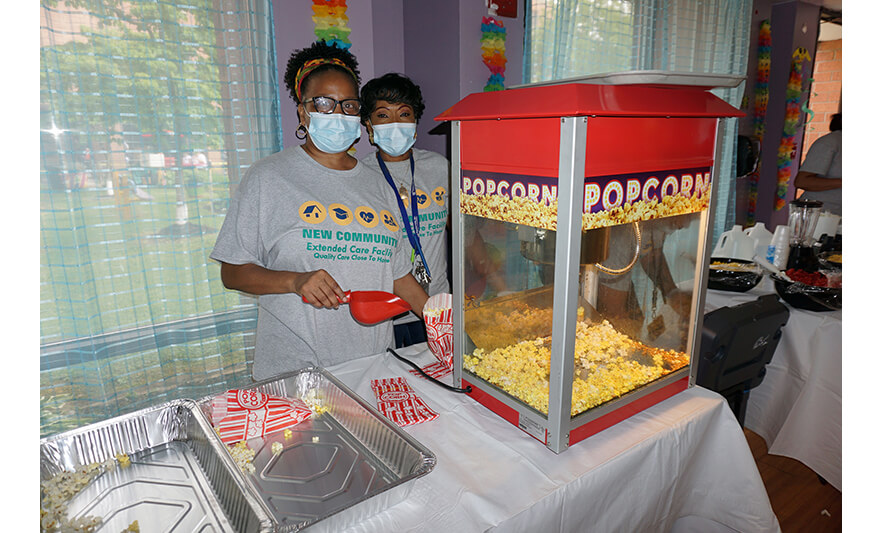 https://www.newcommunity.org/wp-content/uploads/2023/05/Extended-Care-Cookout-5-19-2023-Popcorn-machine-for-web.jpg